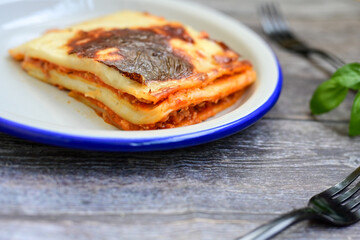   Delicious Home made Lasagna  with minced meat,tomato sauce and spinach  on a wooden rustic ...