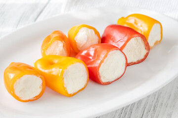 Colorful Baby Bell Peppers Stuffed With Cream Cheese on White Plate