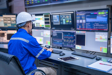 Engineer working at control room, Manager control system, Technician man monitoring program from a...