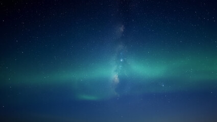 Obraz premium Vast starry night sky with glowing green aurora borealis and milky way