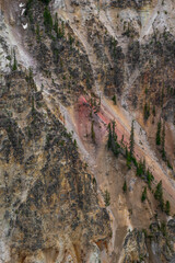 Vibrant Red Mineral Streaks in Yellowstone Canyon Walls