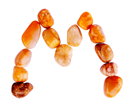 letter M is made of stone with a white background. The creative shapes of the letters of the alphabet are arranged with stones