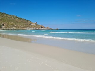 Praia Grande (Big Beach) Arraial do Cabo, Rio de Janeiro - Brazil: sunny morning, coastal atmosphere of the winter, white sand and crystal-clear blue waters in Brazilian Caribbean.
