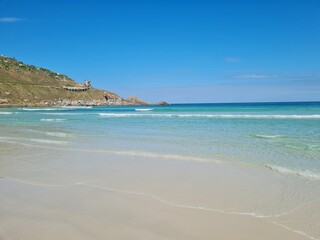 Praia Grande (Big Beach) Arraial do Cabo, Rio de Janeiro - Brazil: sunny morning, coastal atmosphere of the winter, white sand and crystal-clear blue waters in Brazilian Caribbean.