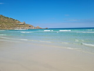 Praia Grande (Big Beach) Arraial do Cabo, Rio de Janeiro - Brazil: sunny morning, coastal atmosphere of the winter, white sand and crystal-clear blue waters in Brazilian Caribbean.