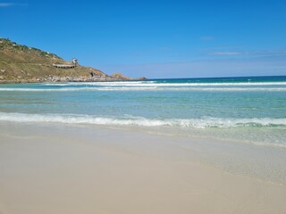 Praia Grande (Big Beach) Arraial do Cabo, Rio de Janeiro - Brazil: sunny morning, coastal atmosphere of the winter, white sand and crystal-clear blue waters in Brazilian Caribbean.