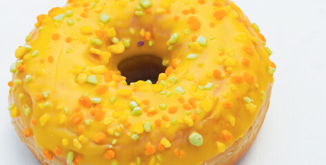 Colorful Sprinkle-Covered Donut on a White Background Showcasing Vibrant Textures and Sweet Appeal
