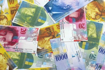 Swiss franc banknotes. The current francs money bills lies on table