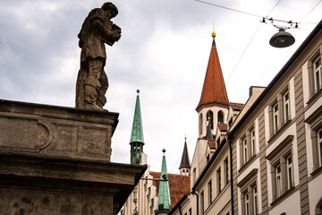 Historic Toy Museum In Munich Near Marienplatz: Old Tower With Red Roof And Green Spire Framed By...