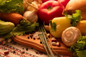 Fresh vegetables arranged on a wooden board with herbs and spices, showcasing a colorful selection...