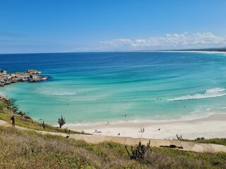 Praia Grande (Big Beach) Arraial do Cabo, Rio de Janeiro - Brazil: sunny morning, coastal atmosphere of the winter, white sand and crystal-clear blue waters in Brazilian Caribbean.