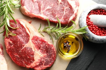 Pieces of raw beef meat and spices on table, flat lay