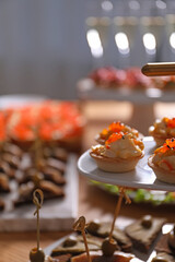 Buffet menu. Tasty stuffed tartlets on stand, closeup