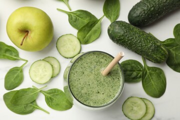 Tasty spinach smoothie and ingredients on white table, flat lay