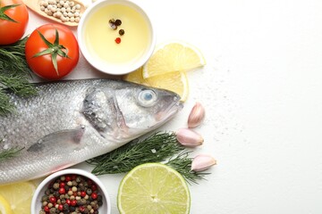 Fresh raw seabass fish with spices on white table, flat lay and space for text. Seafood delicacies