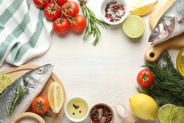 Frame of fresh raw seabass fish with spices on white wooden table, flat lay and space for text....