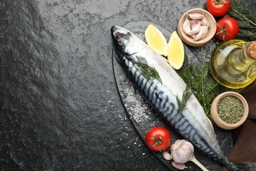 Seafood delicacies. Fresh raw mackerel and spices on black table, flat lay. Space for text