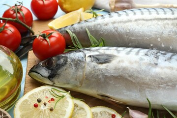 Fresh raw mackerels and spices on table, closeup. Seafood delicacies