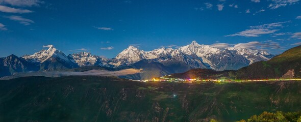 Panorama of Meili Snow Mountains at night