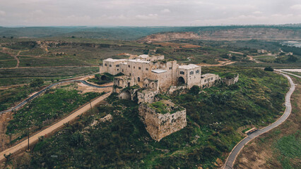 Obraz premium Ancient Fortress Amidst Green Fields
