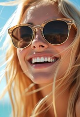 Close-up portrait of a happy smiling blonde woman in sunglasses on a sunny day.