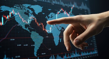 A finger points to a digital world map displayed on a computer screen, overlaid with financial charts and graphs indicating global market trends