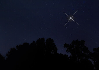 Bright Christmas Star shining in the night sky