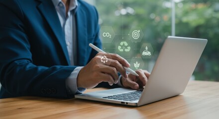 Eco-friendly business professional with sustainability icons. Person using laptop with green environmental symbols. Digital workspace with CO2 and recycling concepts.