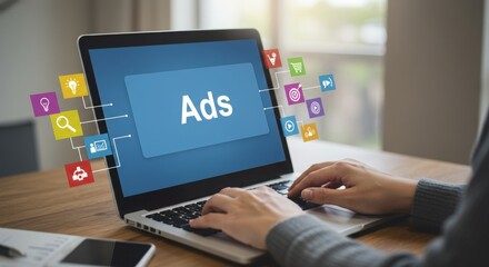 Fototapeta premium Digital advertising concepts on laptop screen. Marketing professional working with ads and icons. Modern workspace with promotional strategies.