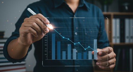 Professional analyzing data with stylus on transparent screen. Futuristic business technology with interactive bar graph. Corporate executive reviewing financial trends.