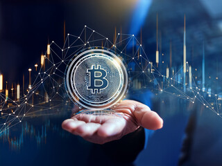 Hand grasping illuminated Bitcoin icon surrounded by holographic circuit and data interface

