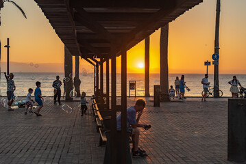 people on the beach enjoying the sunset on Tenerife island
