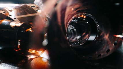 An old twisted color film lies on a dark background, symbolizing memories on the film. The film...