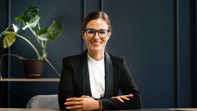 Middle-aged businesswoman, successful director, works in a modern office. Concept of leadership, success and professional achievements.