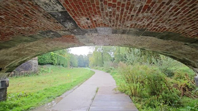 bridge and hiking path in a raining day along citadel Park ( Parc de la Citadelle ) - Lille, France