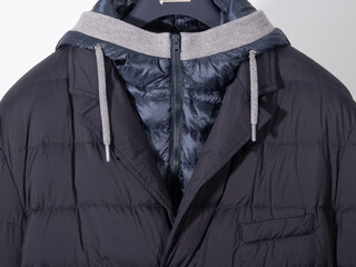 Stylish black puffer jacket designed for versatile wear in cooler weather with a detachable hood...