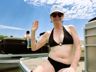 Confident Woman in Black Bikini Enjoying the Lake