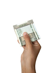 Close-up image of a hand holding a neatly folded bundle of ₹500 Indian rupee notes, receiving money, money handover, transaction. Indian economy, finance, banking.