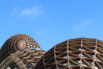 Modern Wooden Dome Structures Against Clear Blue Sky, Architectural Design