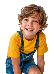 Happy young boy in denim overalls and a yellow shirt smiling against a transparent background.