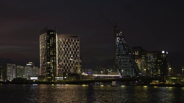 sunset night illumination abu dhabi city bay modern hotel construction exterior panorama timelapse 4k united arab emirates  