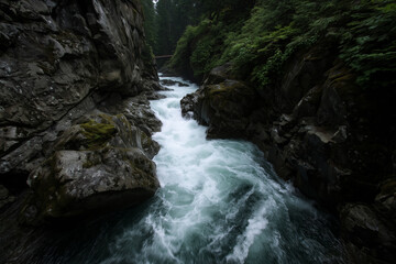 A roaring mountain river slices through a granite gorge