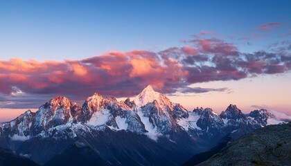 majestic mountain peaks at sunrise with pink clouds and snow capped summits