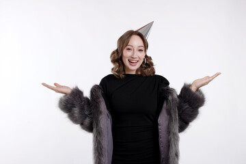 Birthday celebration. Happy woman with party cone on white background