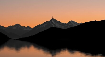 Obraz premium Silhouetted Alpine Peaks at Sunset Reflecting on Still Lake
