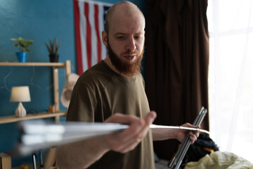 Traveler assembling tent poles at home indoors. Tourism, hiking and travel concept