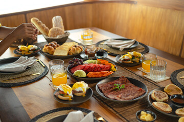 Savoring a delightful breakfast on deck aboard a traditional Phinisi boat in Labuan Bajo. The breathtaking morning views of the surrounding islands and calm waters set the perfect scene for starting t