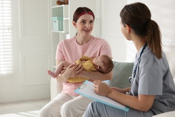Mother and her cute baby having appointment with pediatrician in hospital