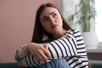 Scared woman suffering from paranoia at home