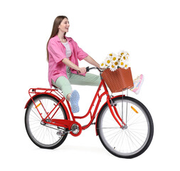 Smiling woman riding bicycle with basket of flowers against white background